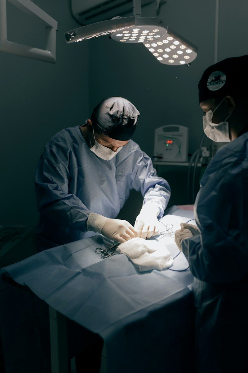 Surgeons performing a medical procedure under bright lights